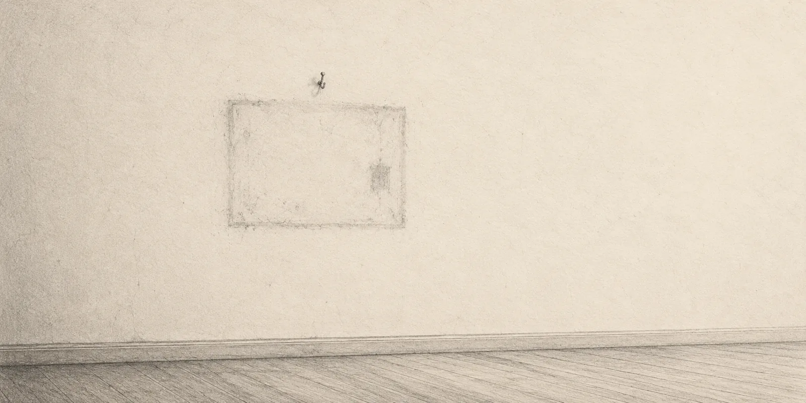 On an almost empty gallery wall, a faint outline remains below the hook where a picture frame once hung.